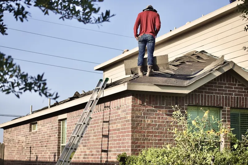 Professional roofer working on a residential roof in Oakhurst